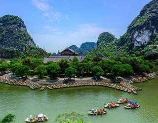 Tourists join boat tours inside the Trang An limestone landscape in Ninh Binh Province, northern Vietnam. Photo by Shutterstock/Anh Hung.